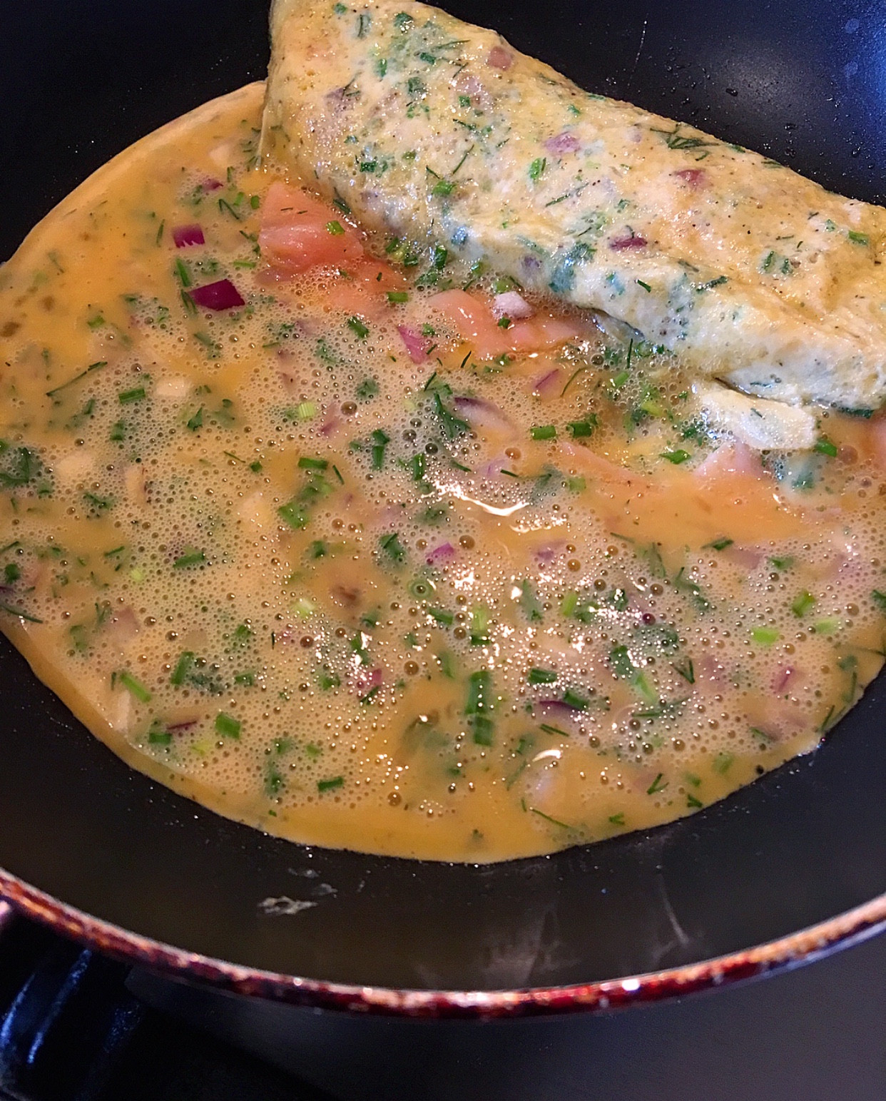 Here I’ve rolled it and moved it to the top of the pan. Then I added another ¼ of the egg and herb mixture.