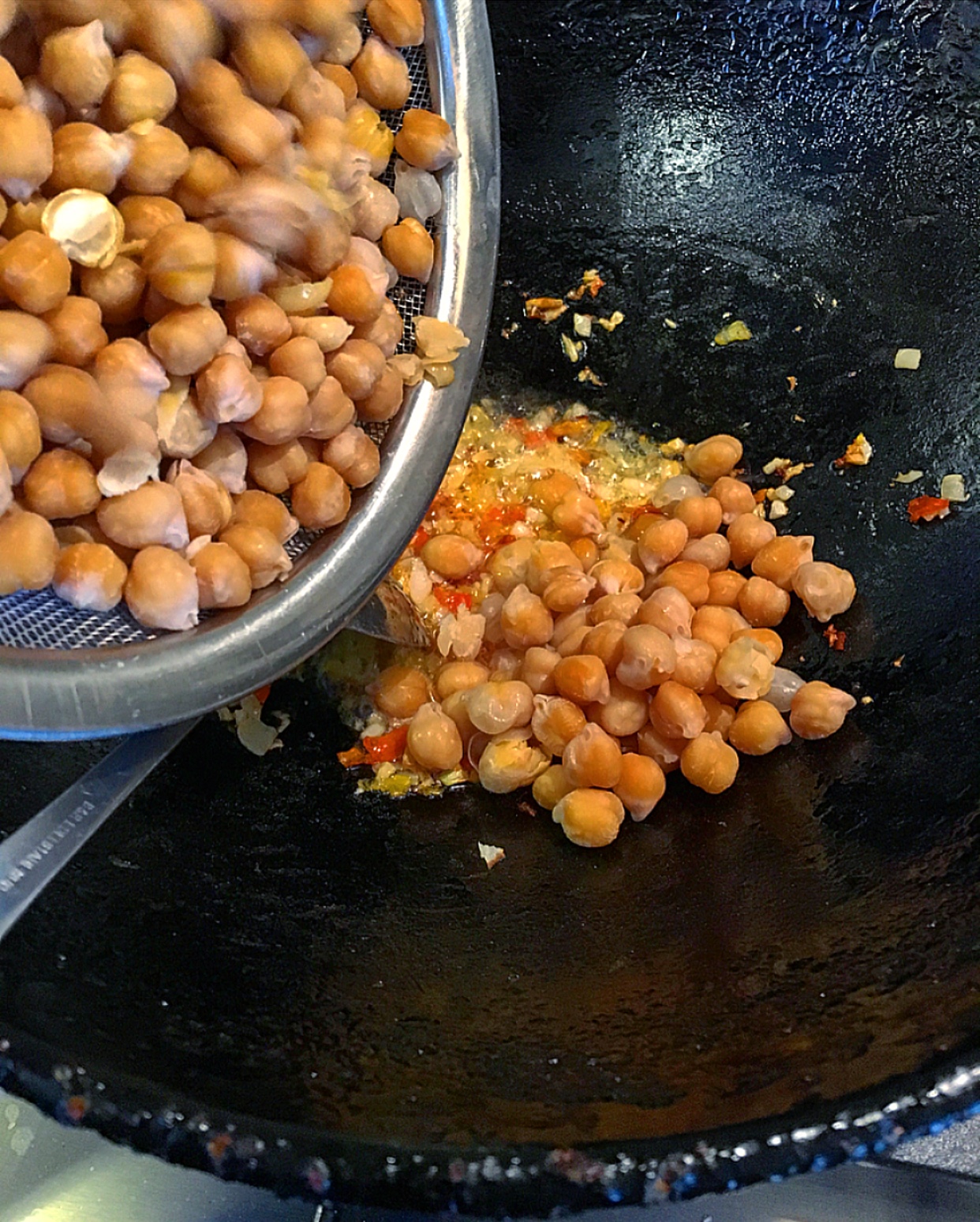 When the garlic and onion mixture are light brown add the chickpeas.